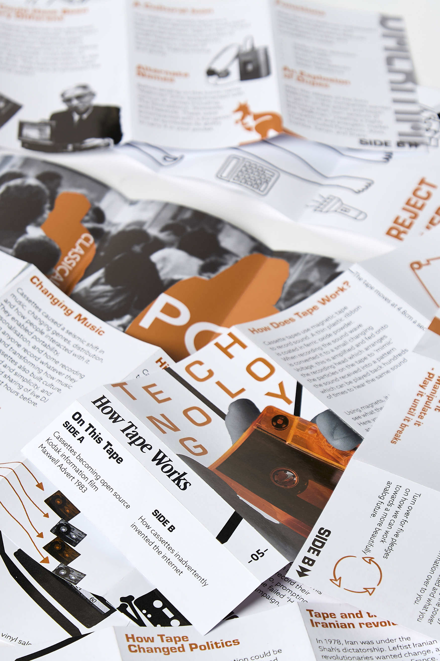 A printed magazine spread with orange, black, and white graphics, combining text, diagrams, and photographs about tape technology, music, and political history.