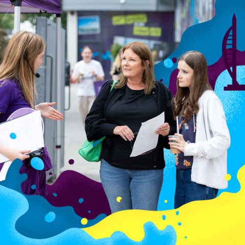 Two women listening to a Student tour guide 