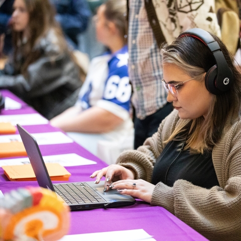 Woman with headphones using a laptop