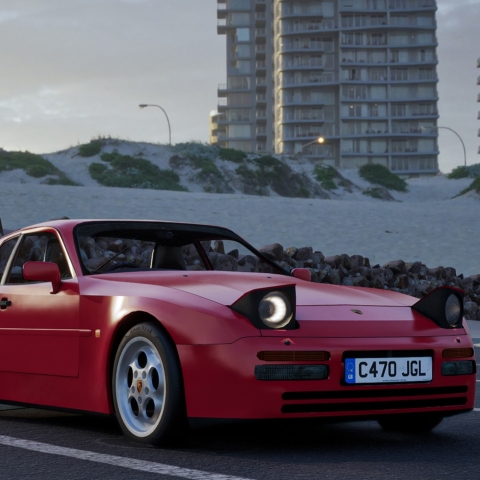 Image of a computer generated porsche - the car has its headlights up is bright red and is parked in a car park with buildings and snow in the background