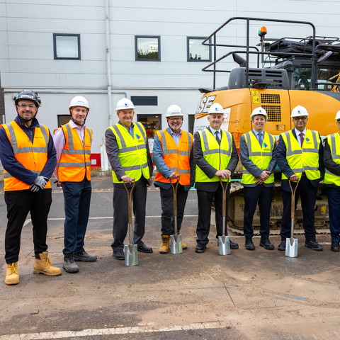 Eldon multistorey carpark project team in hi vis standing in front of a large digger
