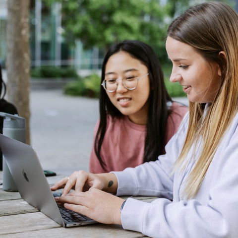 Three students studying on Laptop in Eldon centre outdoor space