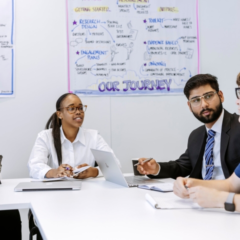 Colleagues discussing ideas at a meeting table