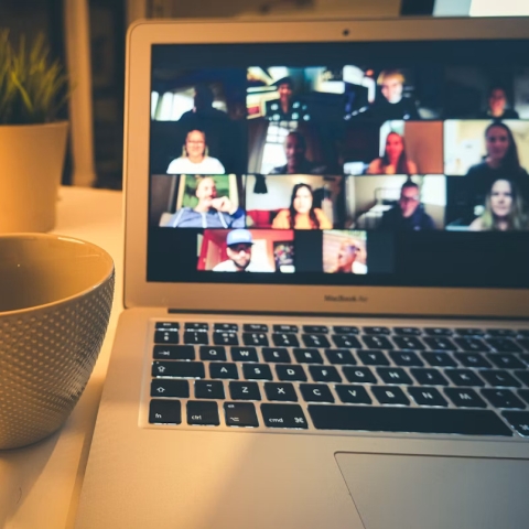 Photo of a cup of tea and a laptop with a zoom meeting taking place