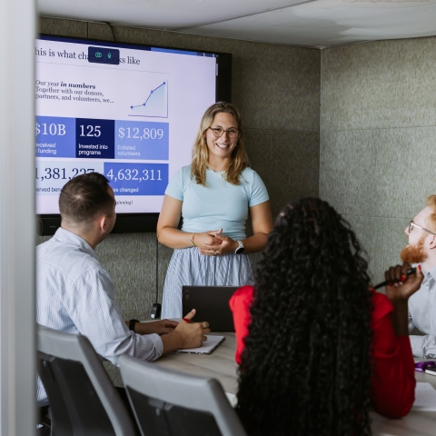 Colleagues discussing ideas in a meeting room