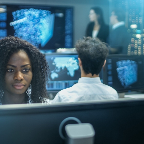 Female cyber security worker working at computer