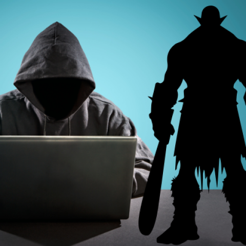 Person in a black hooded jacket over a laptop with mythical creatures surround them