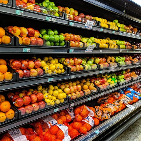 supermarket shelves with fruit and veg