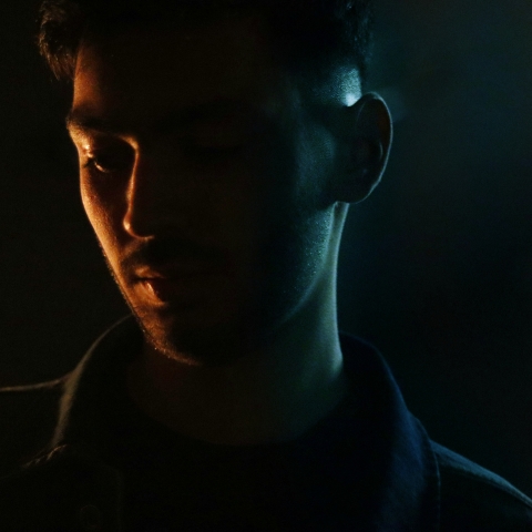 image of male in dark shadow background