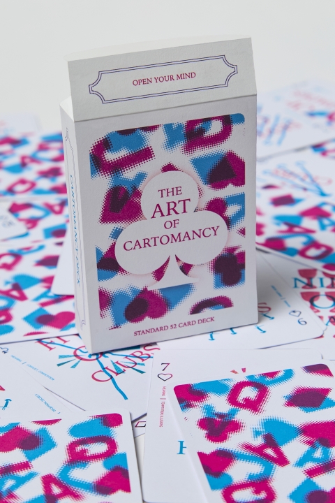 a box of playing cards on top of other cards titled "the art of cartomancy"