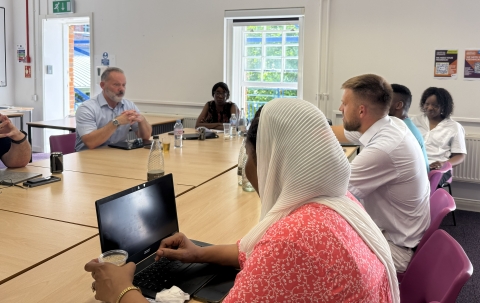 Group of male and female academics at a round table discussion