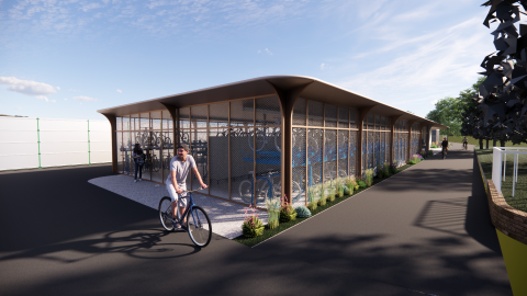 Person on bike with the proposed cycle hub behind