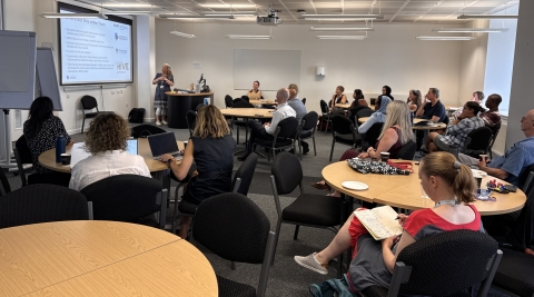 Classroom of people listening to a presentation