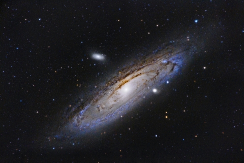 Image of outer space showing darkness, light sources and stars to depict the Universe