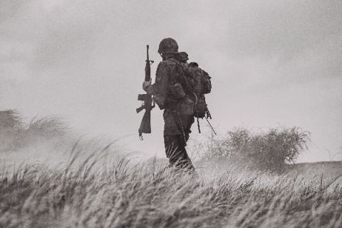 Military fighter holding riffle -  Photo by Eduard Delputte on Unsplash