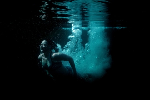 Woman swimming outdoors in Cornwall