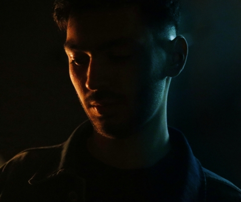image of male in dark shadow background