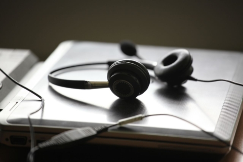 A pair of headphones on a closed laptop