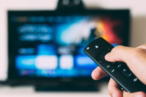 Person using TV remote