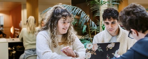 Three students conversing in a study space