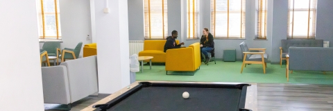 Rees Hall, two students are relaxing in the communal area