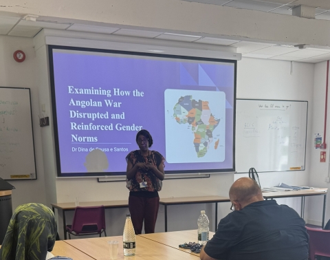 Academic at the front of a classroom presenting a seminar