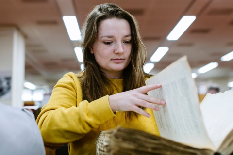Hannah Coombs researching in the library