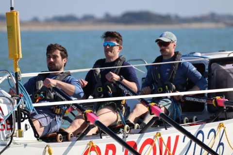 Three rowers on an ocean rowing boat