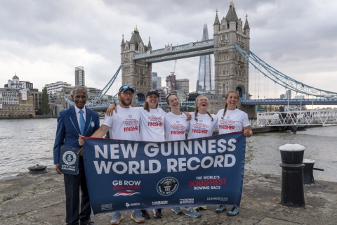 Team of rowers in front of Tower Bridge, London