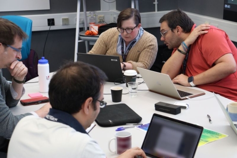 Scientists and engineers work at their computers in the new Space Mission Incubator facility