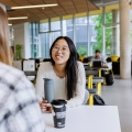 Student hanging out in Eldon cafe with a friend.