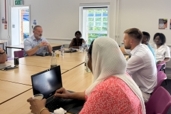 Group of male and female academics at a round table discussion