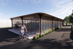Person on bike with the proposed cycle hub behind