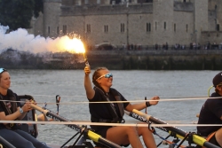 Rower Grace Church holding a flare after completing a row around Great Britain