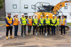 Eldon multistorey carpark project team in hi vis standing in front of a large digger