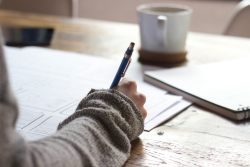 unsplash image of someone writing with a pen