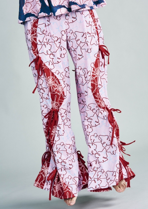 Photo of trousers designed by student. The trousers and pink and flowering with a red furry hemming material.