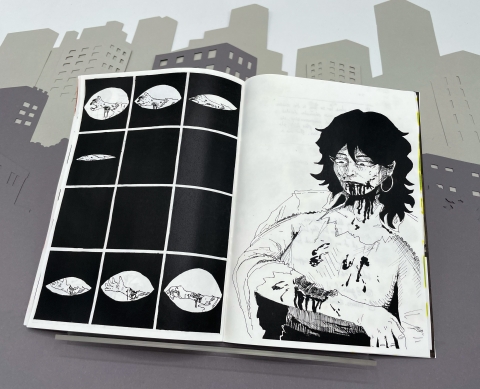 An open black‑and‑white graphic novel showing a sequence of close‑up eye panels on the left page and an injured long‑haired character on the right, set against a grey cityscape backdrop.