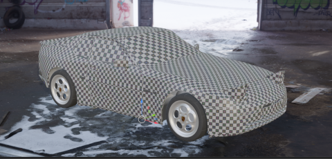A 3D car model sits in an abandoned industrial garage, covered in a grey‑and‑white checkerboard UV texture. The scene includes graffiti‑covered walls, scattered debris on the floor, and open doors revealing snow outside.