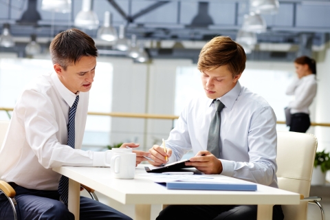 Two students looking at a business challenge at a table